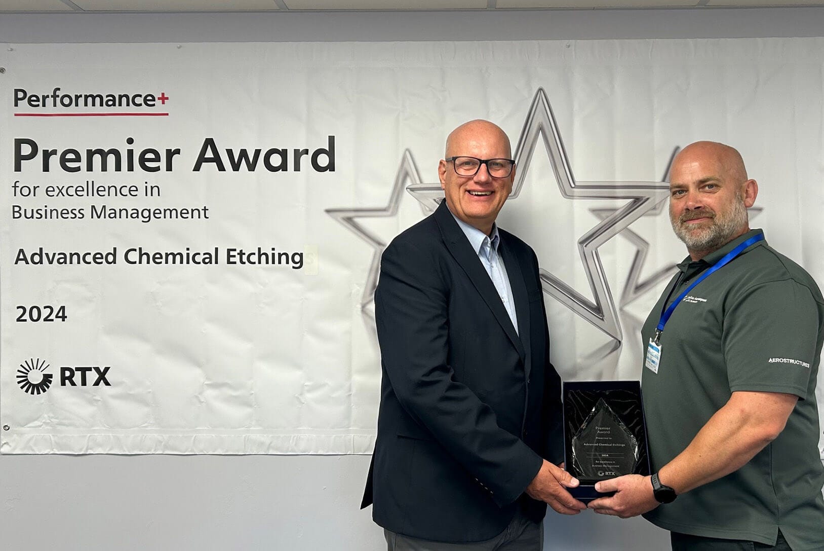 ACE’s Ian Whateley (left) receives the RTX Premier Award for Business Management performance